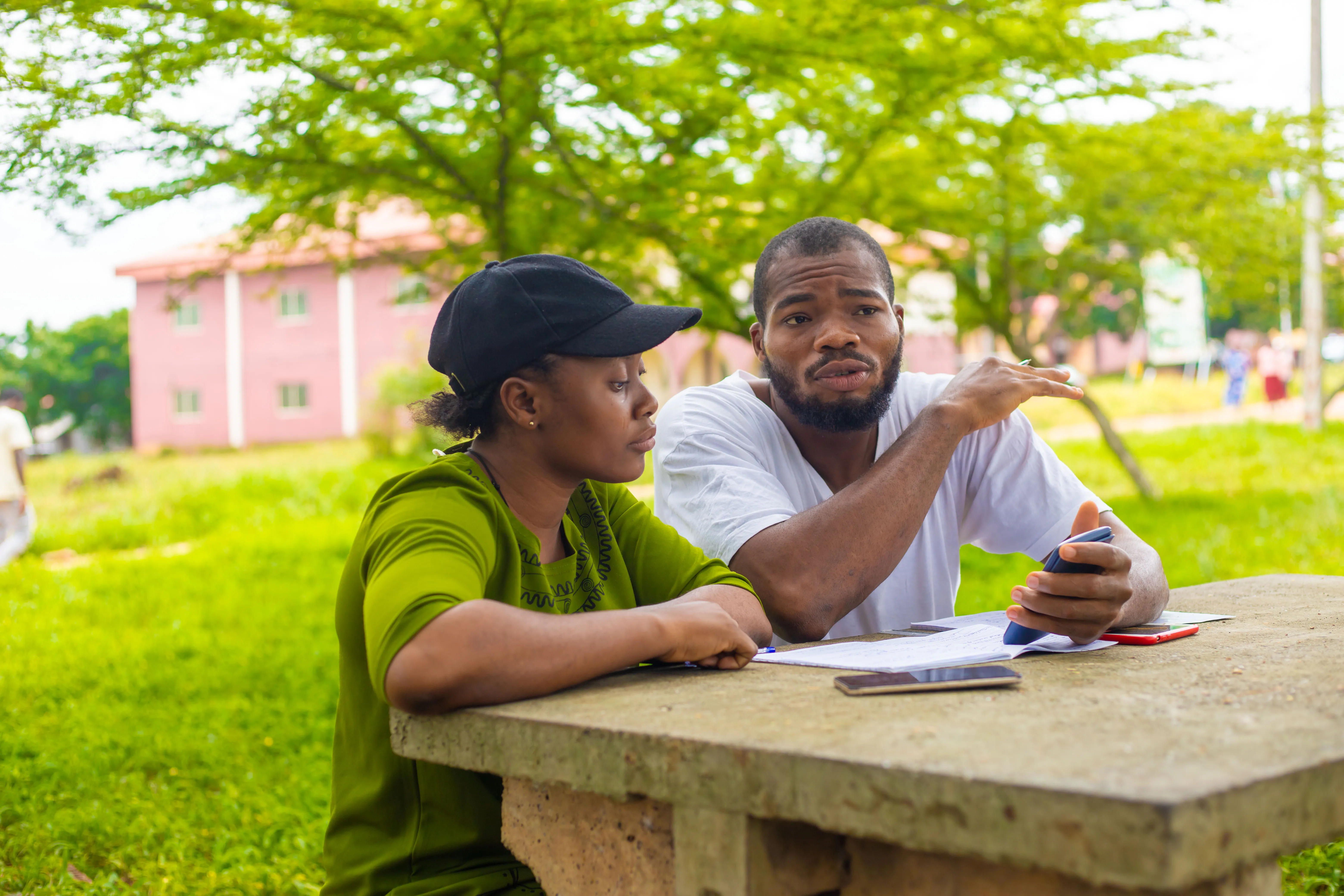handsome-african-student-explaining-their-course-work-his-course-mate